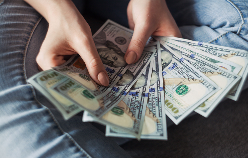 Female hands holding cash bills